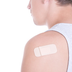 close up of medical adhesive plaster on male shoulder isolated o