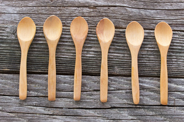 Wooden spoons on wooden background