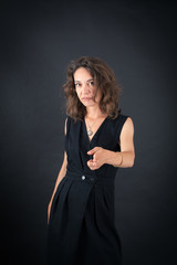 Beautiful woman doing different expressions in different sets of clothes: gun sign