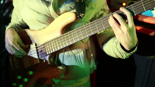 Bassist playing at a rock concert.