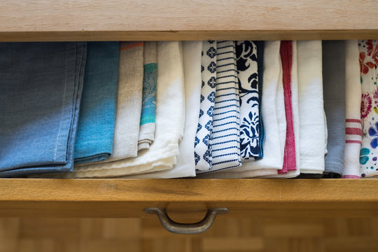Tea towels arranged in a drawer of dining table
