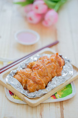 Baked chicken breast on wood table.