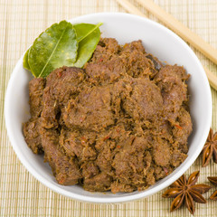 Rendang Daging - Dried beef curry with coconut milk and spices. Traditional Indonesia, Malaysian and Singaporean dish.