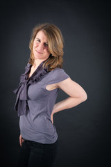 Fototapeta premium Beautiful woman doing different expressions in different sets of clothes: backache