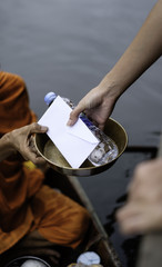 Give alms to a Buddhist monk while on board .