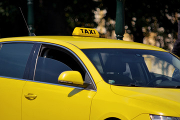 Classic yellow taxi car with a yellow taxi sign on the roof. Classic yellow cab car with a yellow...
