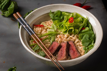 A bowl of Chinese ramen noodles with beef, Chinese cabbage, chil