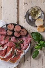 A set of various French and Italian meats on the vintage metal p