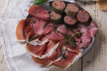 A set of various French and Italian meats on the vintage metal p