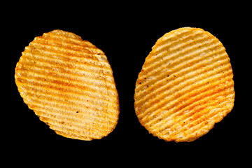Ribbed potatoes chips on black