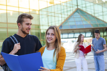 Happy student having conversation next modern college. Education concept