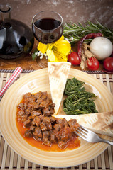 Veal stew heart of the hunter, with cake and spinach