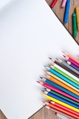 Open Blank Sketch book with Chalk colored and Colour pencils