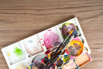 Paintbrushes and paint box, artist tools.