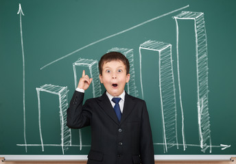 boy in suit show graphs on school board