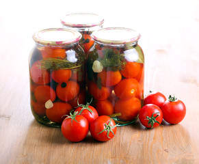 Jars with  preserved pickled tomatoes