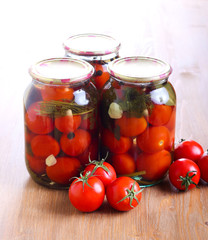Jars with  preserved pickled tomatoes