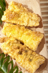 floured cod cooked in a pan