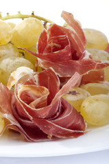 white grapes with ham roses on a white background