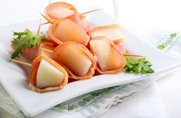 Slices of melon wrapped with ham