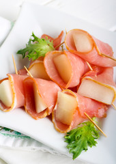 Slices of melon wrapped with ham