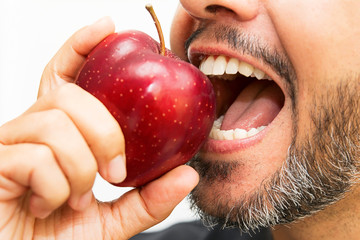 Man bitting an apple