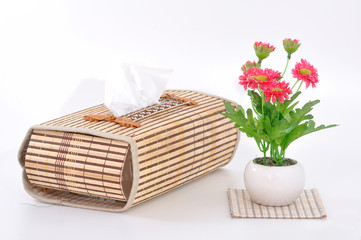 Classic tissue box with flower in vase.