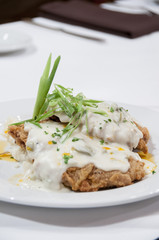 gourmet chicken fried steak with country gravy and chile oil.