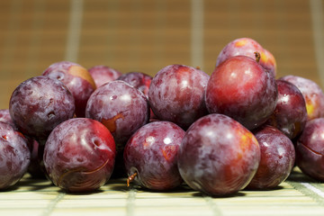 Freshly harvested red plums with natural wax bloom