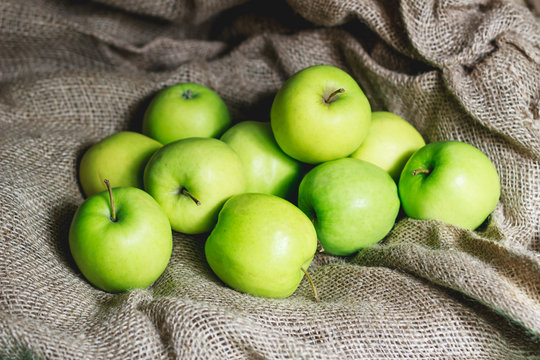 Green apples on brown suck