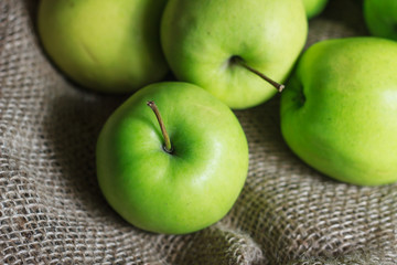 Green apples on brown suck