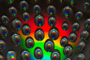 Water drops reflections on rainbow surface