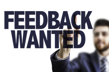 Business man pointing the text: Feedback Wanted