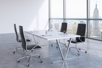 Modern meeting room with huge windows looking at the New York City, Manhattan. Black leather chairs...