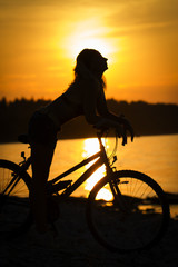 silhouette of a girl on a bicycle