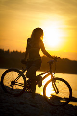 Fototapeta na wymiar silhouette of a girl on a bicycle