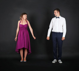 Cute young couple on black background