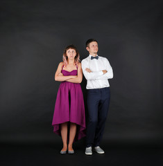 Young couple on black background