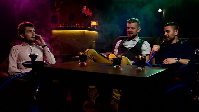 Boys smoking hookah in the caffee