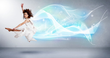 Naklejka premium Cute teenager jumping with abstract blue scarf around her
