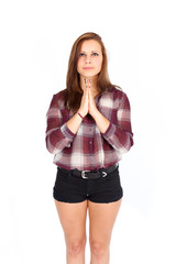 Fototapeta premium Beautiful woman doing different expressions in different sets of clothes: praying