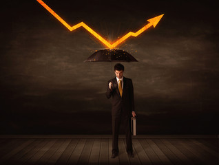 Businessman standing with umbrella keeping orange arrow