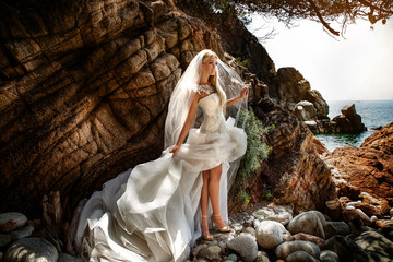 Sensual woman in wedding dress posing outdoor. - 89668389