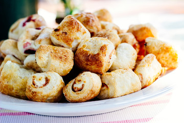 Tasty rolls with cheese and ham on a plate 