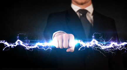 Business man holding electricity light bolt in his hands