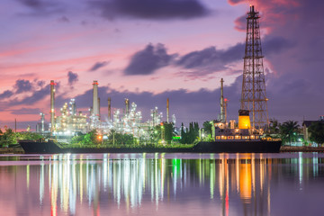 Fototapeta premium Oil tank ship mooring in oil refinery industry at twilight time