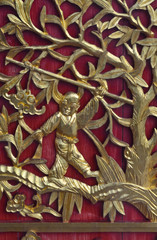 Golden chinese style wood carved on red wall at Chinese temple