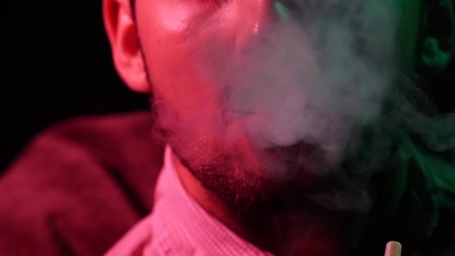 Portrait man lips with smoke cloud. Slow motion. silhouette