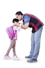 Dad kiss his daughter before go to school