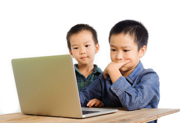 Two boys using notebook look serious